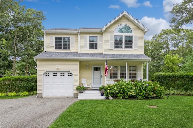view of front of home with a garage, a front yard, roof with shingles, and driveway