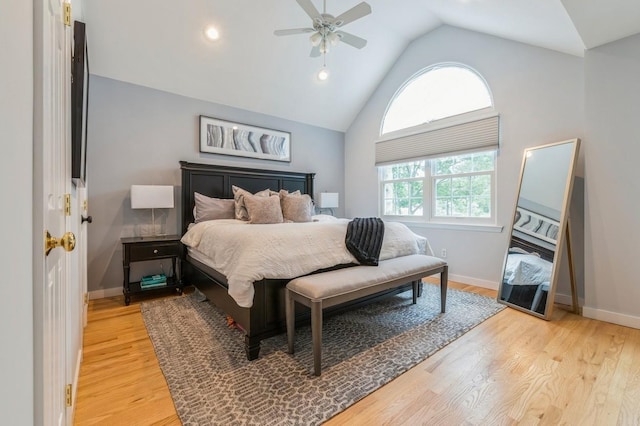 bedroom with light wood-type flooring, lofted ceiling, baseboards, and ceiling fan