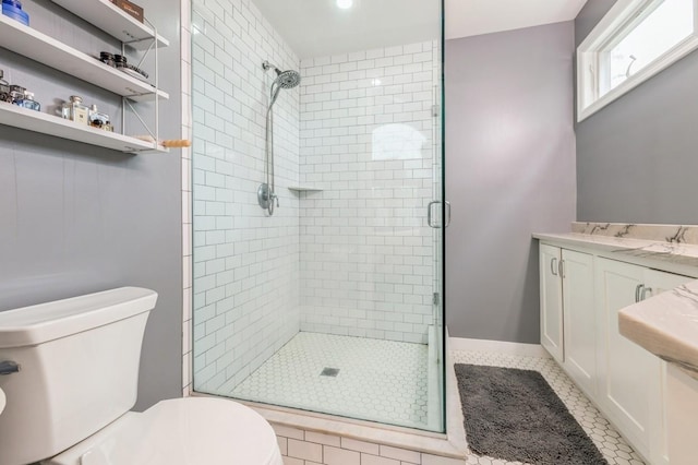 full bathroom featuring a shower stall, toilet, and tile patterned floors