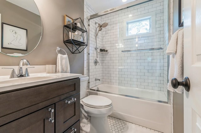 bathroom with vanity, toilet, and shower / bath combination with glass door