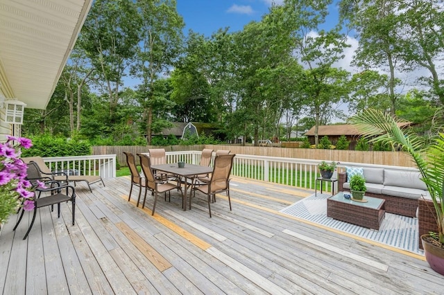 deck featuring an outdoor living space, outdoor dining area, and a fenced backyard