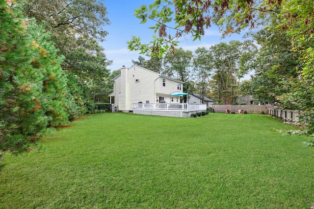 view of yard featuring a wooden deck and fence