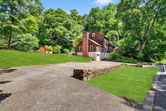 285 Grand St, Croton-On-Hudson, NY 10520 - view of grassy yard with driveway and a storage unit