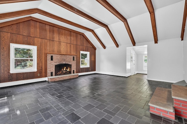 285 Grand St, Croton-On-Hudson, NY 10520 - unfurnished living room with a baseboard radiator, healthy amount of natural light, a fireplace, and wood walls