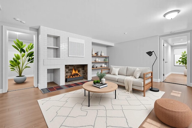 285 Grand St, Croton-On-Hudson, NY 10520 - living room featuring wood finished floors, a fireplace, built in features, and recessed lighting