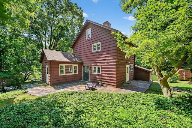 285 Grand St, Croton-On-Hudson, NY 10520 - back of property featuring a chimney, a patio area, and a yard