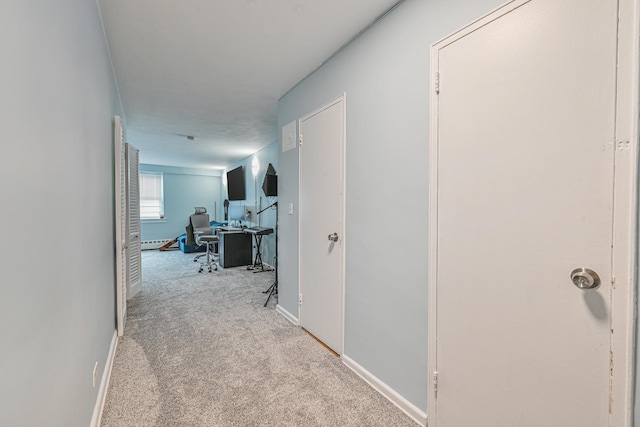 8900 170th St Unit 7N, Jamaica, NY 11432 - hallway with baseboard heating, baseboards, and carpet floors