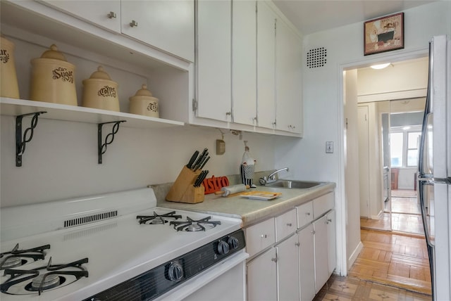 3131 Grand Concourse Unit 11J, Bronx, NY 10468 - kitchen with white appliances, white cabinets, open shelves, and a sink