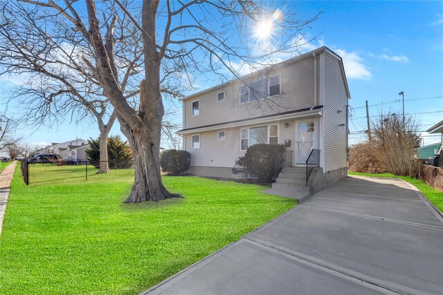 7 Howard Ave, Freeport, NY 11520 - back of house with a lawn and driveway