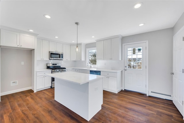 7 Howard Ave, Freeport, NY 11520 - kitchen with light countertops, recessed lighting, dark wood-style floors, stainless steel appliances, and a baseboard radiator