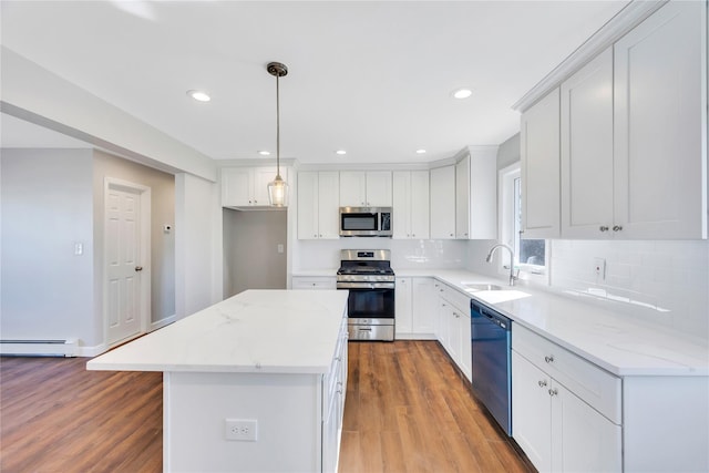 7 Howard Ave, Freeport, NY 11520 - kitchen with a sink, a center island, appliances with stainless steel finishes, wood finished floors, and a baseboard radiator