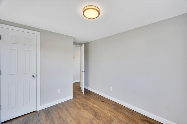 7 Howard Ave, Freeport, NY 11520 - unfurnished bedroom with baseboards and wood finished floors