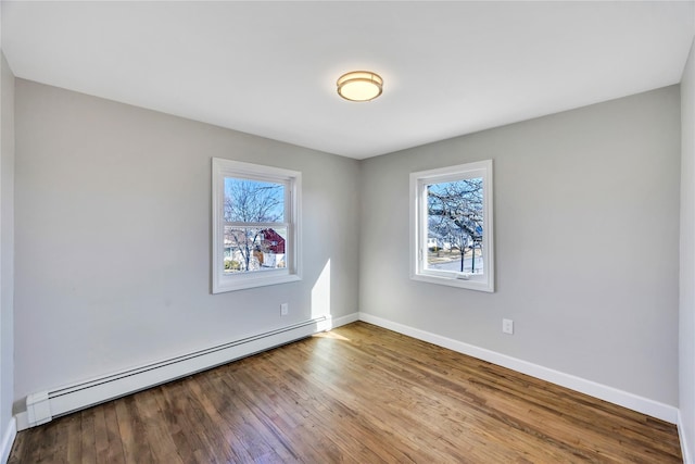 7 Howard Ave, Freeport, NY 11520 - empty room with a baseboard heating unit, baseboards, and wood finished floors
