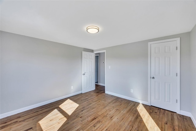 7 Howard Ave, Freeport, NY 11520 - unfurnished bedroom featuring baseboards and wood-type flooring