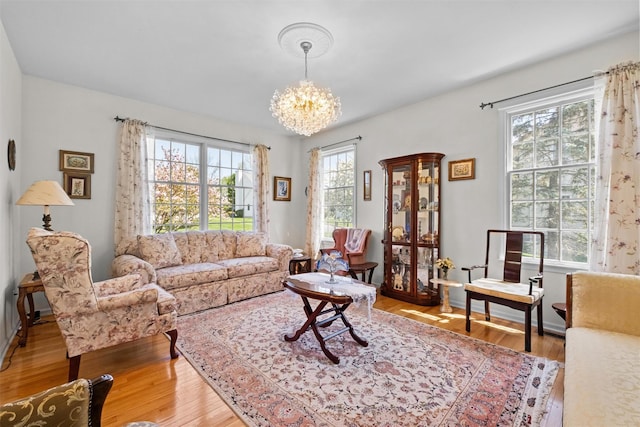 living area featuring light wood finished floors and a notable chandelier
