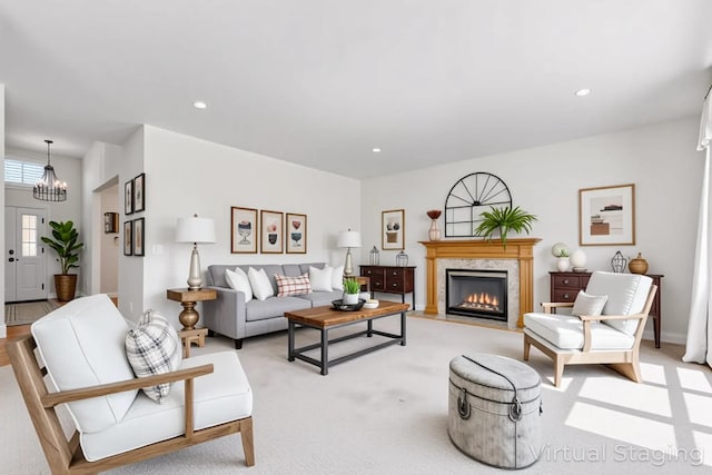 living room with a premium fireplace, a chandelier, light colored carpet, and recessed lighting