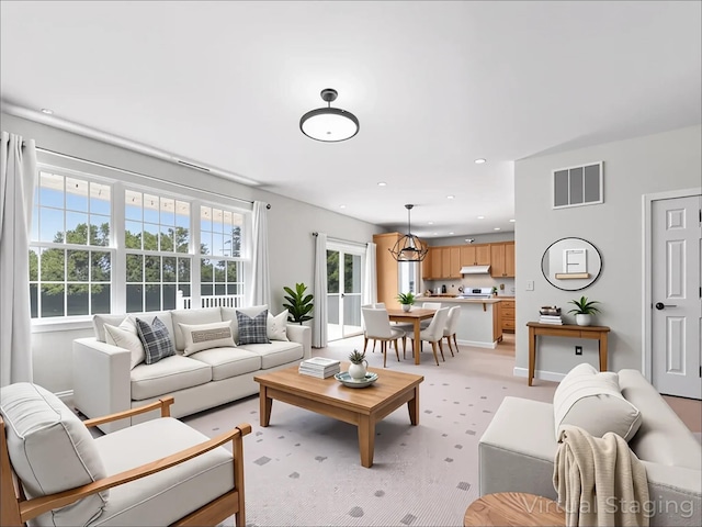 living room featuring visible vents and light carpet