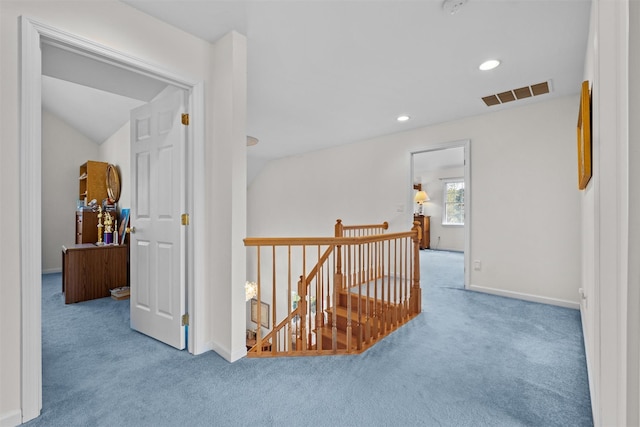 hall featuring recessed lighting, baseboards, visible vents, an upstairs landing, and carpet floors