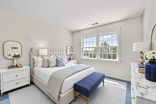 carpeted bedroom with baseboards and visible vents