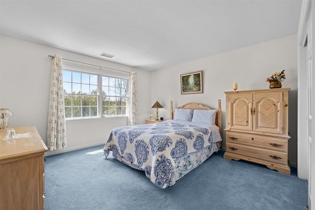 carpeted bedroom featuring baseboards and visible vents