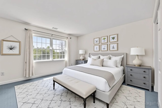 carpeted bedroom featuring baseboards and visible vents