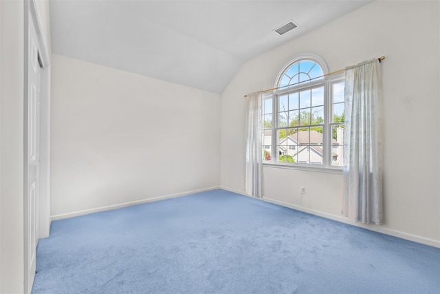 unfurnished room with a healthy amount of sunlight, visible vents, and carpet floors
