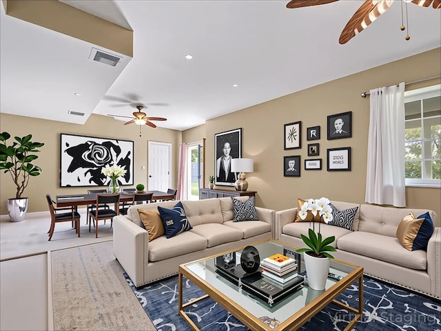 living area featuring visible vents, ceiling fan, and recessed lighting