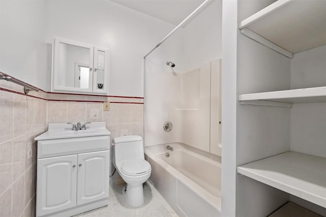 full bathroom featuring shower / bathtub combination, tile walls, toilet, a wainscoted wall, and vanity