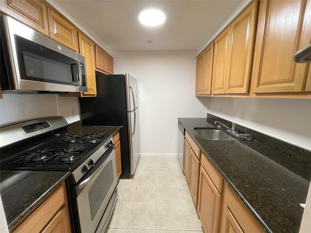 1259 Grant Ave Unit 8A, Bronx, NY 10456 - kitchen with light tile patterned floors, dark stone countertops, stainless steel appliances, and a sink