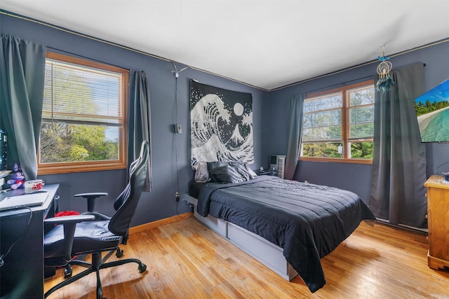 bedroom with baseboards and wood finished floors