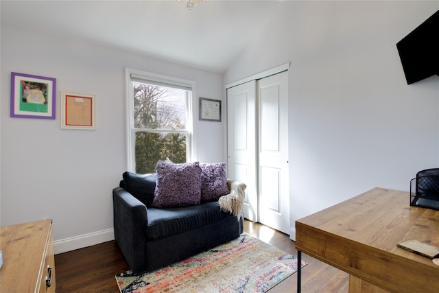 home office featuring dark wood finished floors, vaulted ceiling, and baseboards