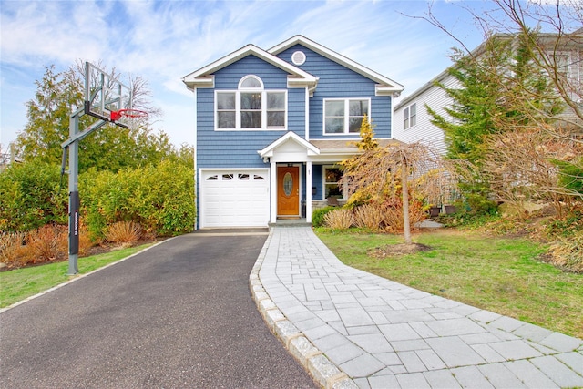 traditional-style home with a front lawn, driveway, and a garage