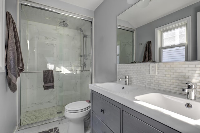 bathroom with a marble finish shower, toilet, backsplash, marble finish floor, and vanity