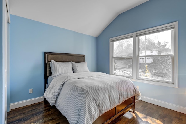 bedroom featuring vaulted ceiling, baseboards, and wood finished floors