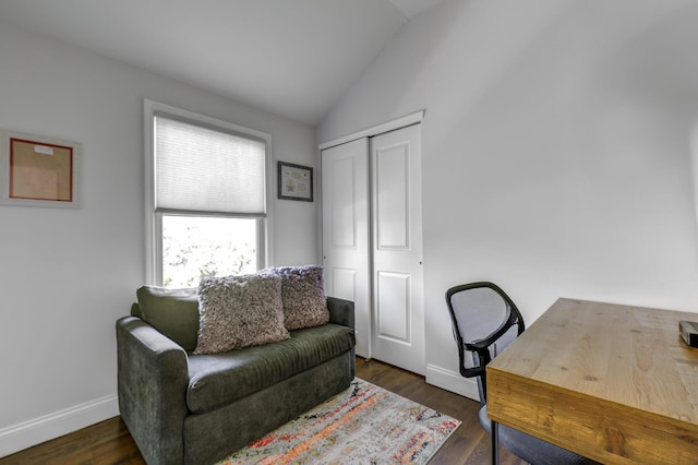 office space with vaulted ceiling, wood finished floors, and baseboards
