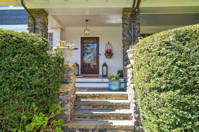 33 Fernwood Rd, Larchmont, NY 10538 - doorway to property featuring covered porch and stone siding
