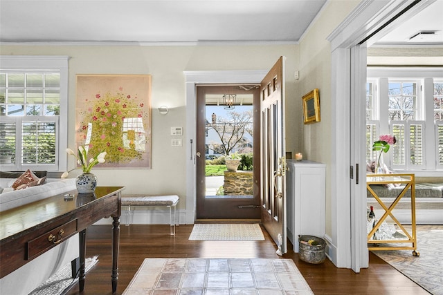 33 Fernwood Rd, Larchmont, NY 10538 - entrance foyer with ornamental molding, a wealth of natural light, and dark wood finished floors