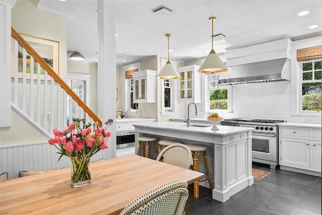 33 Fernwood Rd, Larchmont, NY 10538 - kitchen featuring white cabinets, a sink, tasteful backsplash, light countertops, and high end range