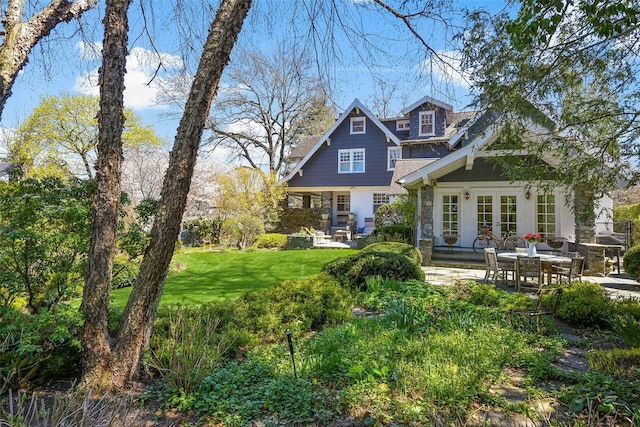 33 Fernwood Rd, Larchmont, NY 10538 - rear view of house with a patio, french doors, a yard, and stone siding