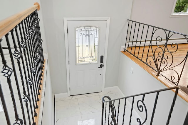 161 Cherry St, Northport, NY 11768 - foyer entrance featuring baseboards, marble look tile flooring, and a baseboard radiator