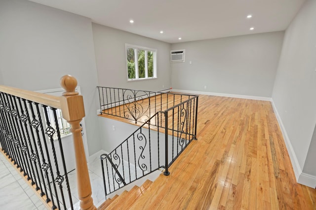 161 Cherry St, Northport, NY 11768 - staircase with wood finished floors, recessed lighting, baseboards, and a wall unit AC