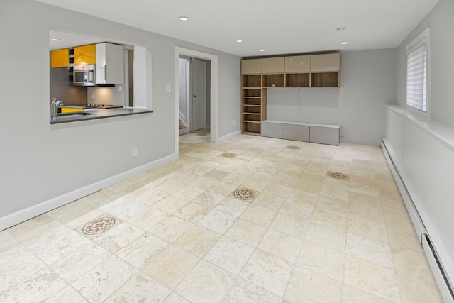 161 Cherry St, Northport, NY 11768 - spare room with baseboard heating, recessed lighting, stairway, a sink, and baseboards
