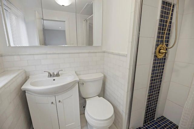 161 Cherry St, Northport, NY 11768 - full bath with tile walls, tiled shower, toilet, vanity, and a wainscoted wall