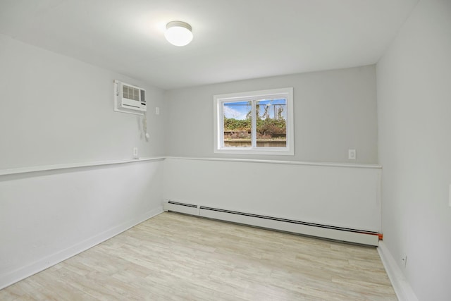 161 Cherry St, Northport, NY 11768 - empty room featuring baseboard heating, an AC wall unit, wood finished floors, and baseboards