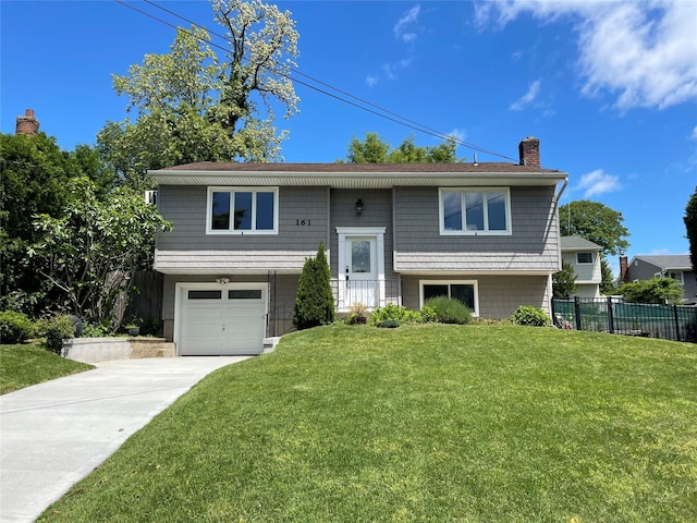 161 Cherry St, Northport, NY 11768 - split foyer home with a chimney, driveway, and an attached garage