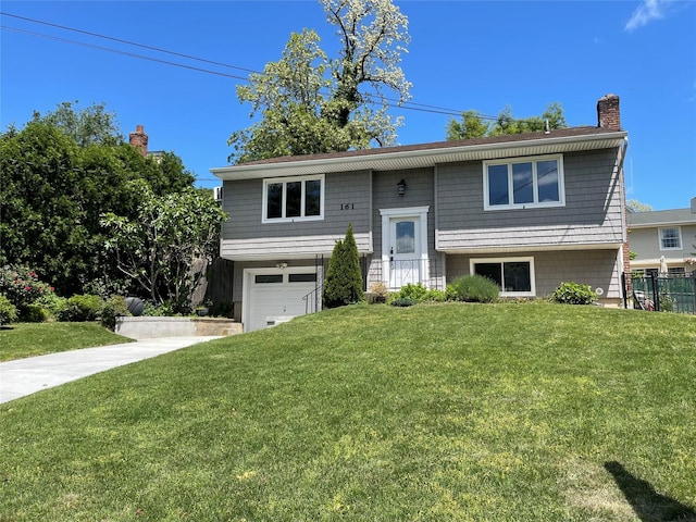 161 Cherry St, Northport, NY 11768 - raised ranch with a chimney, an attached garage, and driveway