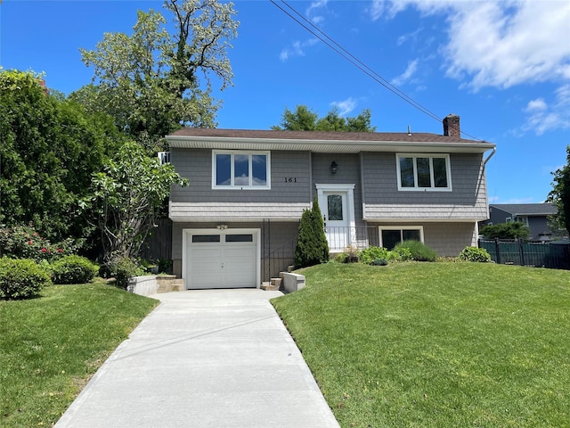 161 Cherry St, Northport, NY 11768 - bi-level home with a chimney, driveway, and an attached garage