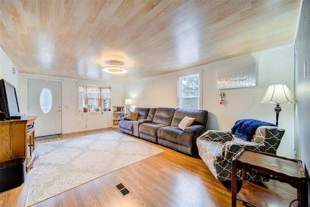 living area featuring wood ceiling, wood finished floors, and visible vents