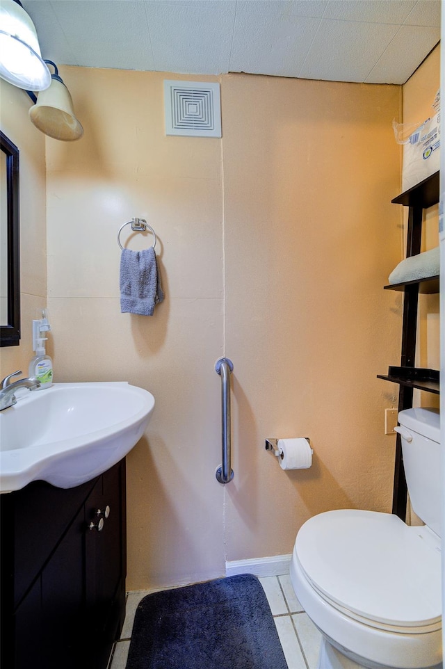 bathroom featuring visible vents, toilet, tile patterned flooring, and vanity