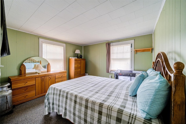 carpeted bedroom featuring multiple windows